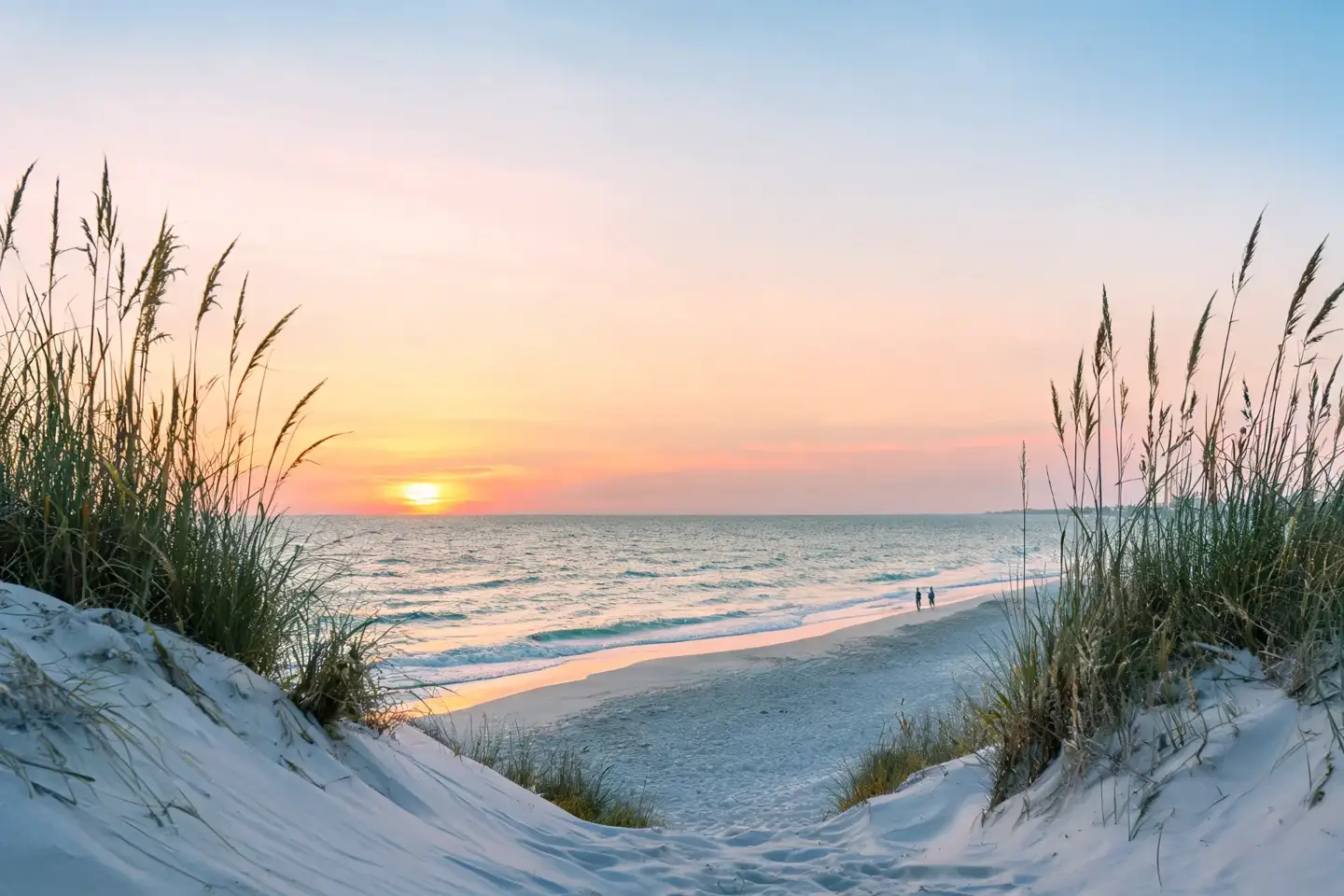 Dune path opening onto a quiet Sarasota shoreline at sunset